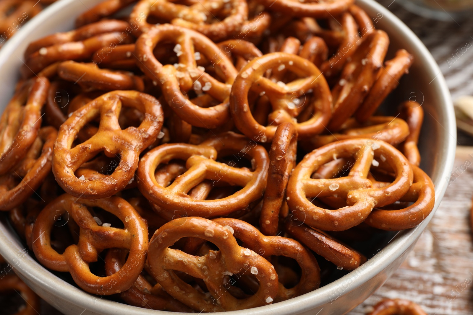 Photo of Delicious salty pretzel crackers on wooden table, closeup