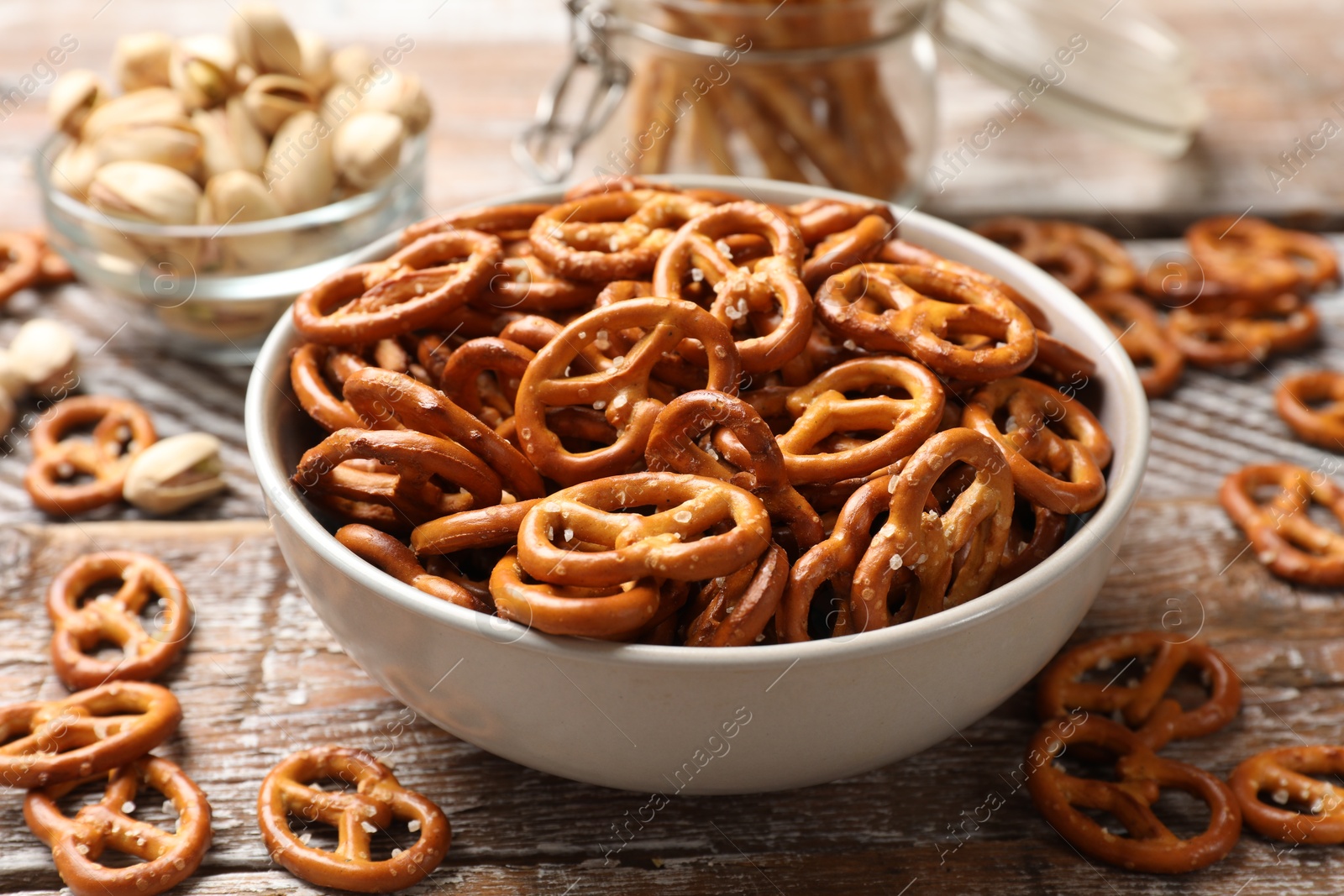 Photo of Delicious salty pretzel crackers on wooden table, closeup