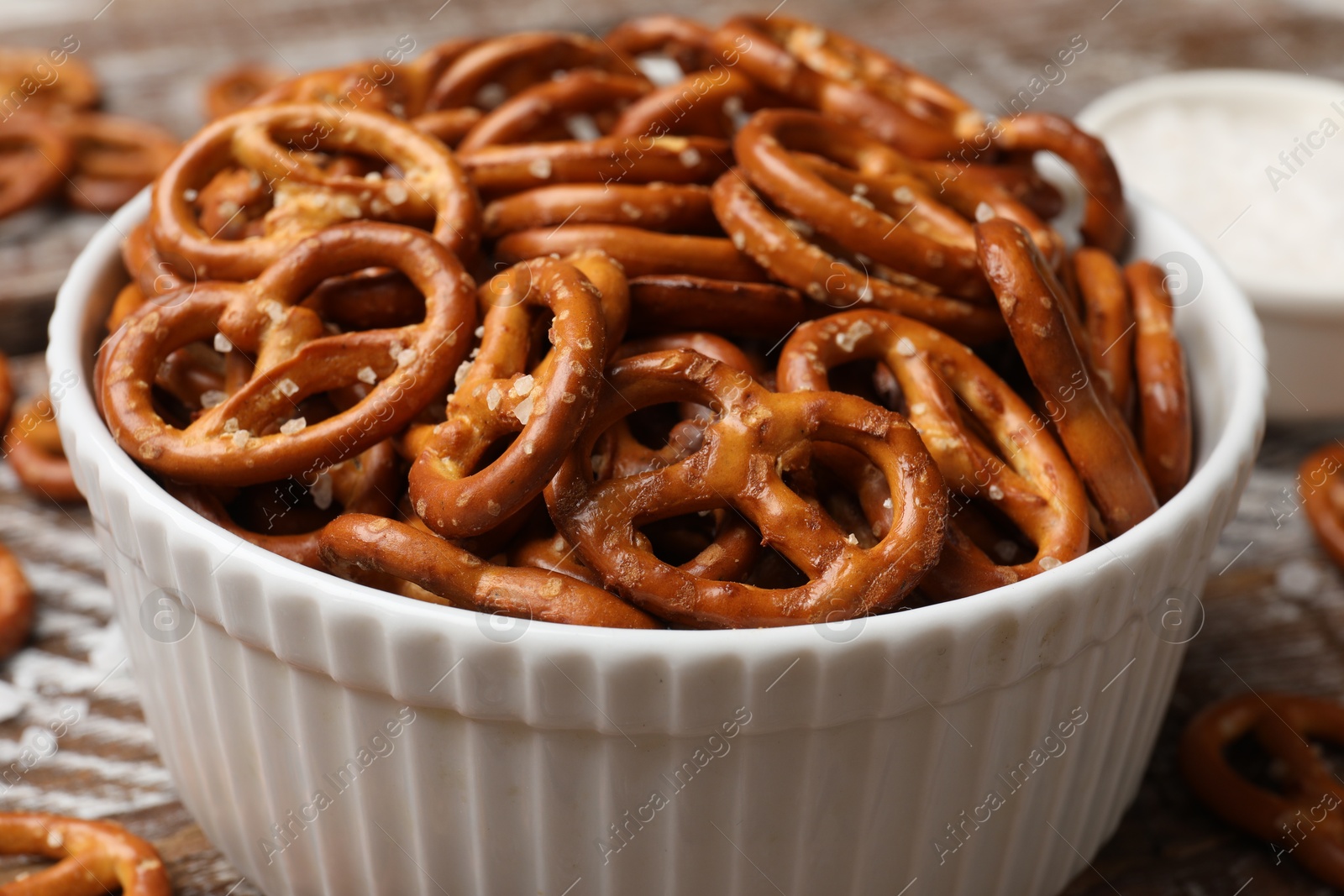 Photo of Delicious salty pretzel crackers on wooden table, closeup