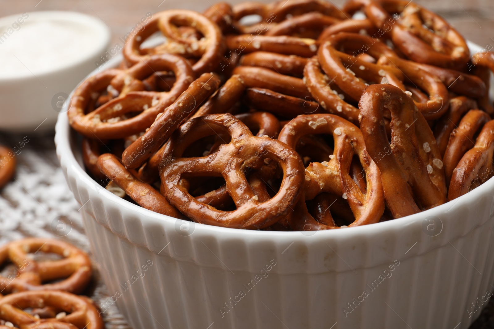 Photo of Delicious salty pretzel crackers on wooden table, closeup