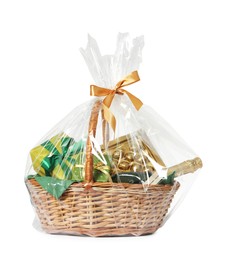 Photo of Wicker gift basket with sparkling wine isolated on white