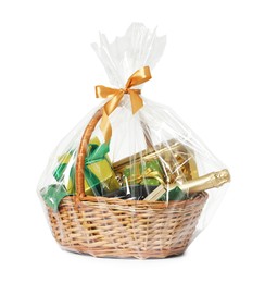 Photo of Wicker gift basket with sparkling wine isolated on white