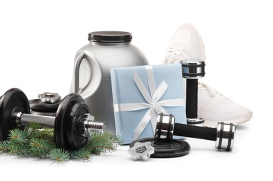 Photo of Dumbbells, container with supplement, sneakers and Christmas decor isolated on white