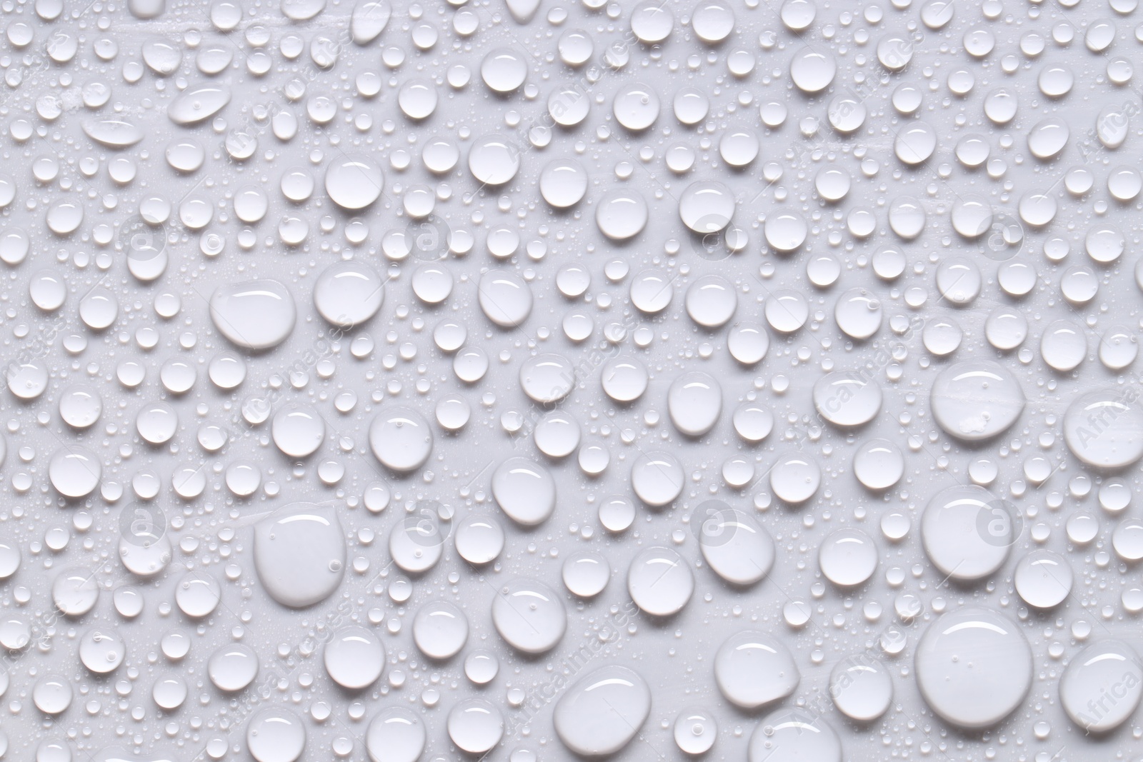 Photo of Water drops on light gray background, top view