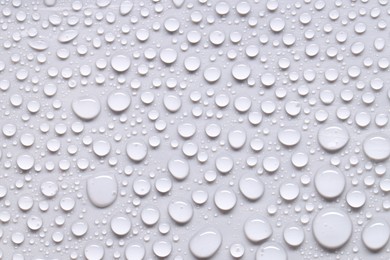 Photo of Water drops on light gray background, top view