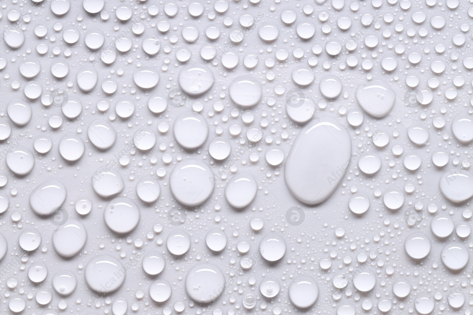 Photo of Water drops on light gray background, top view