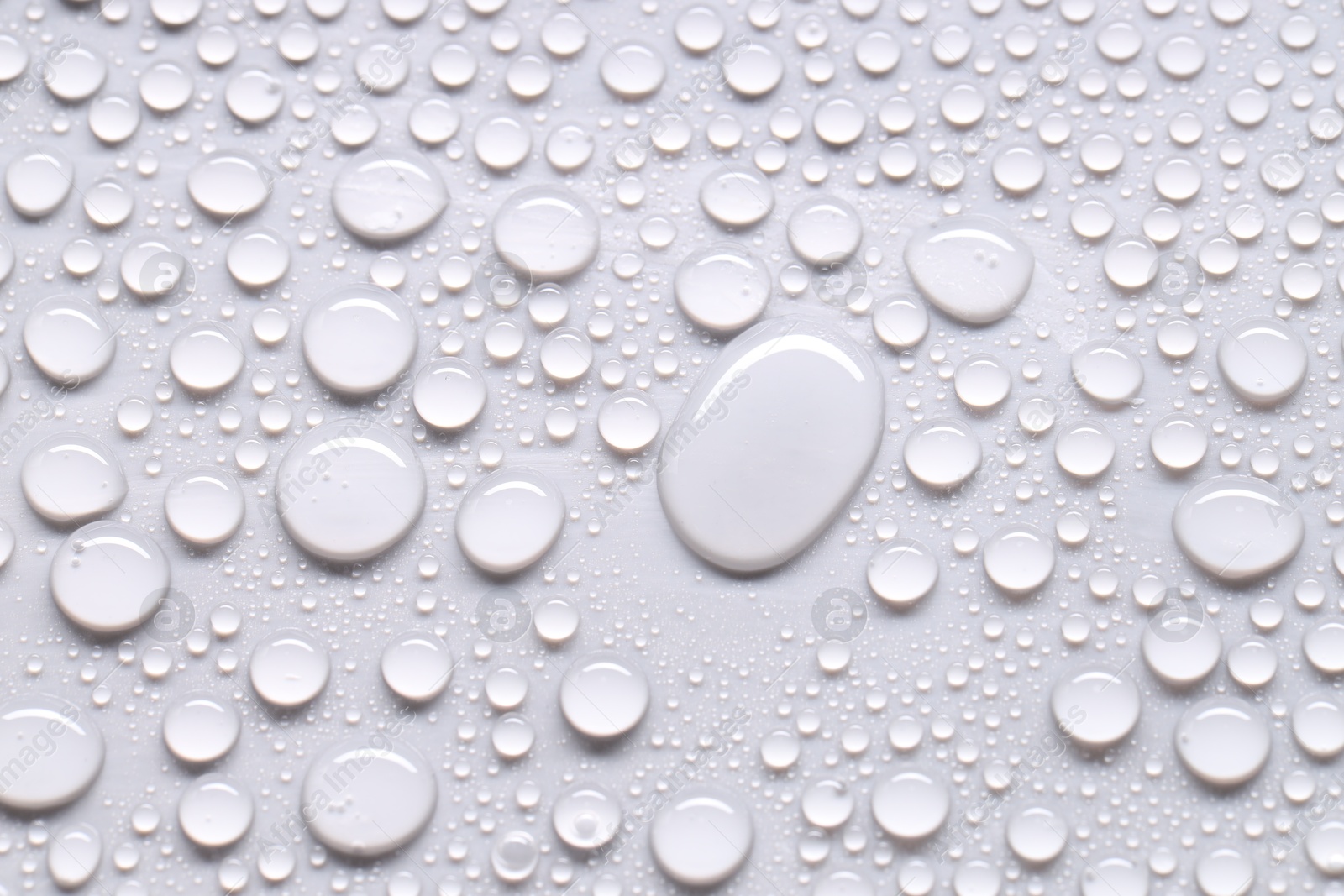 Photo of Water drops on light gray background, top view