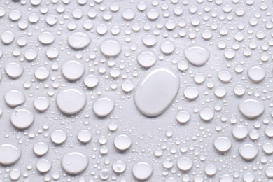 Photo of Water drops on light gray background, top view