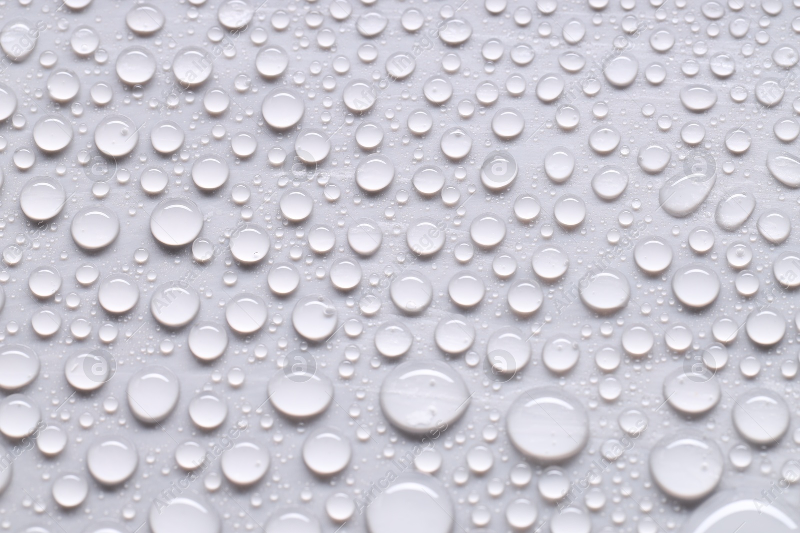 Photo of Water drops on light gray background, top view