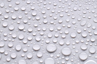 Photo of Water drops on light gray background, top view