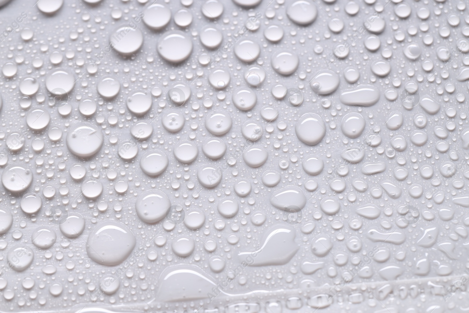 Photo of Water drops on light gray background, top view