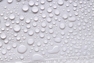 Photo of Water drops on light gray background, top view