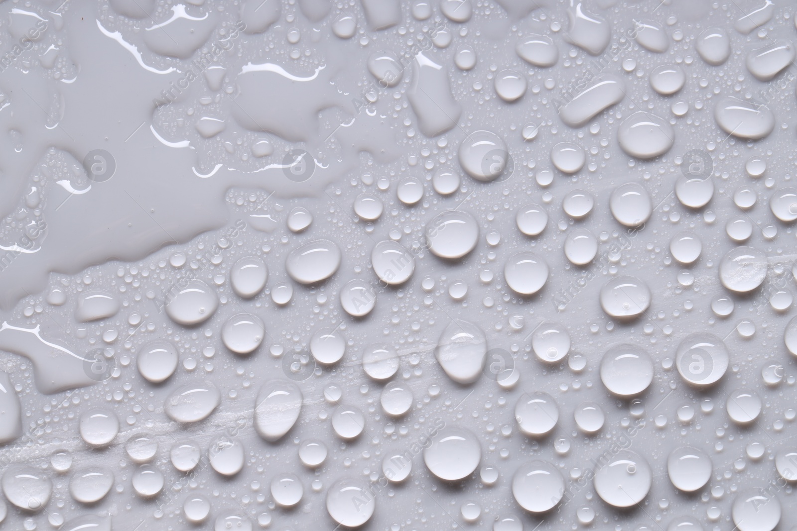 Photo of Water drops on gray background, top view