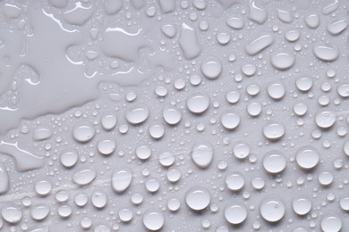 Photo of Water drops on gray background, top view