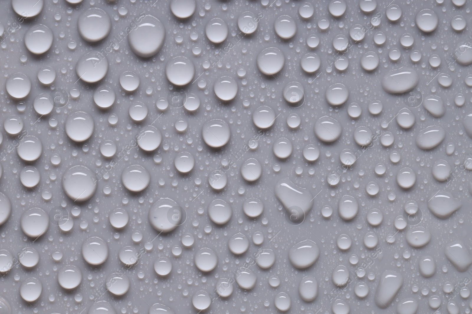 Photo of Water drops on gray background, top view