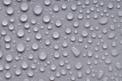 Photo of Water drops on gray background, top view