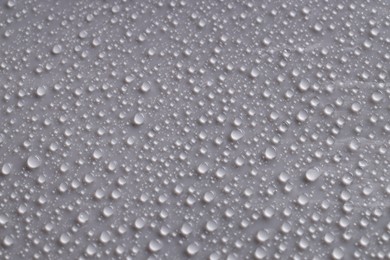 Photo of Water drops on gray background, top view