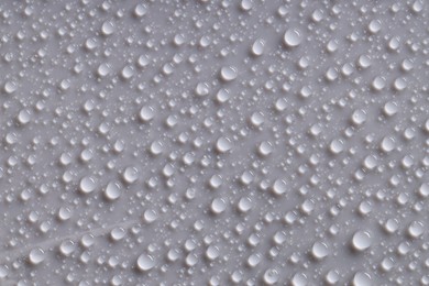 Photo of Water drops on gray background, top view