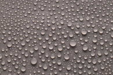 Photo of Water drops on gray background, top view