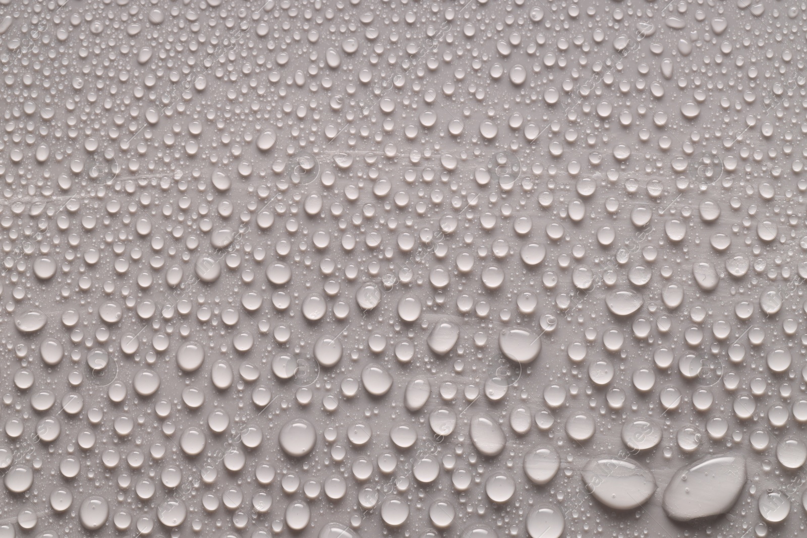 Photo of Water drops on gray background, top view