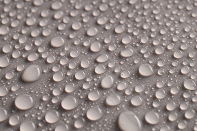 Photo of Water drops on gray background, closeup view