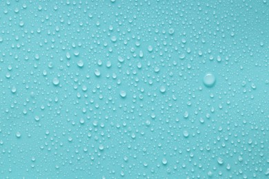 Photo of Water drops on turquoise background, above view