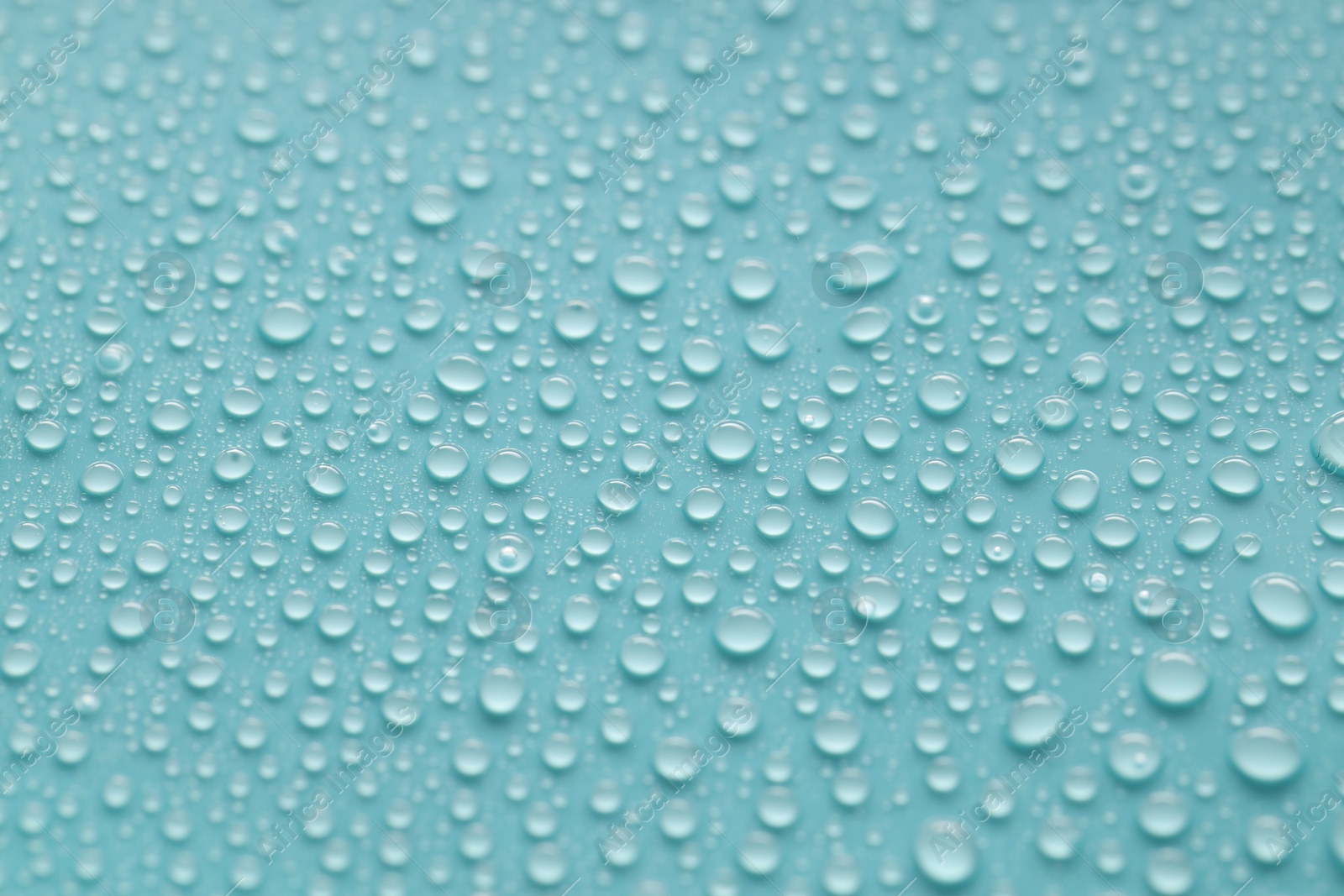 Photo of Water drops on turquoise background, above view