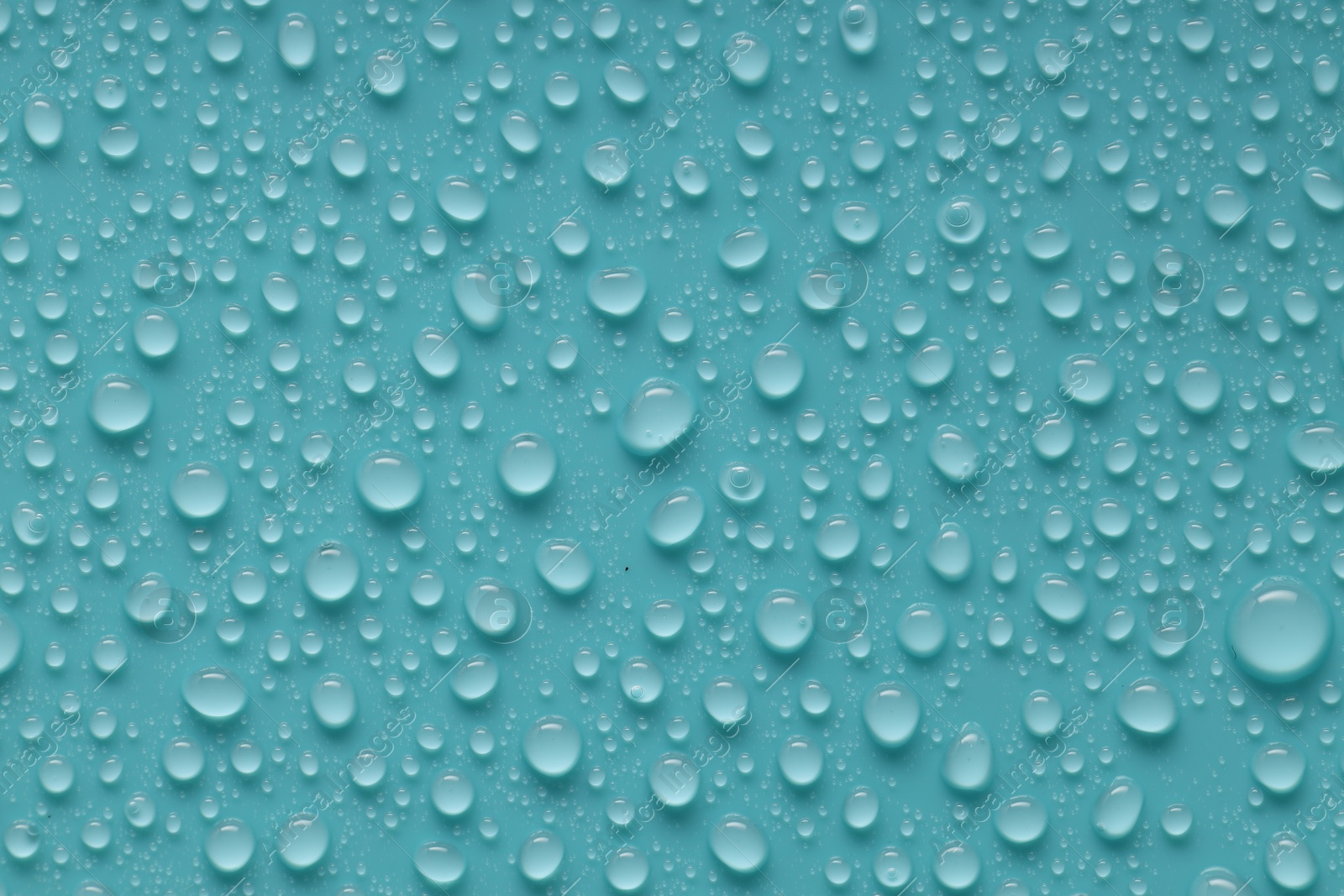 Photo of Water drops on turquoise background, above view