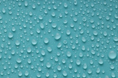 Photo of Water drops on turquoise background, above view