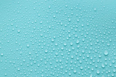 Photo of Water drops on turquoise background, above view