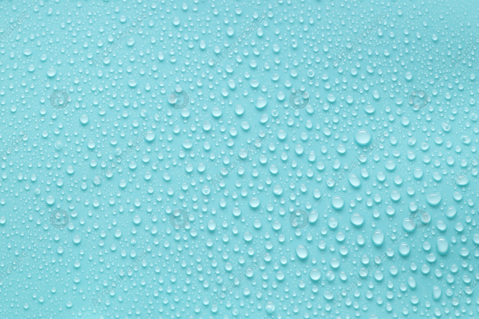 Photo of Water drops on turquoise background, above view