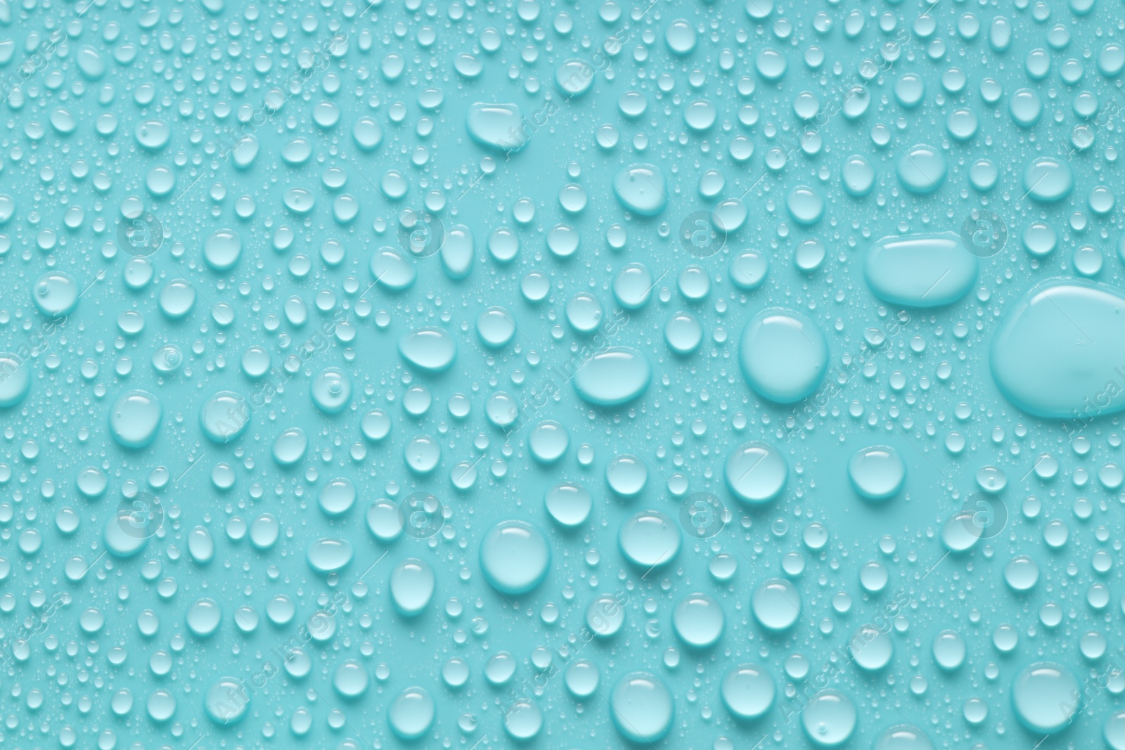 Photo of Water drops on turquoise background, above view