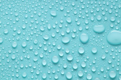 Photo of Water drops on turquoise background, above view