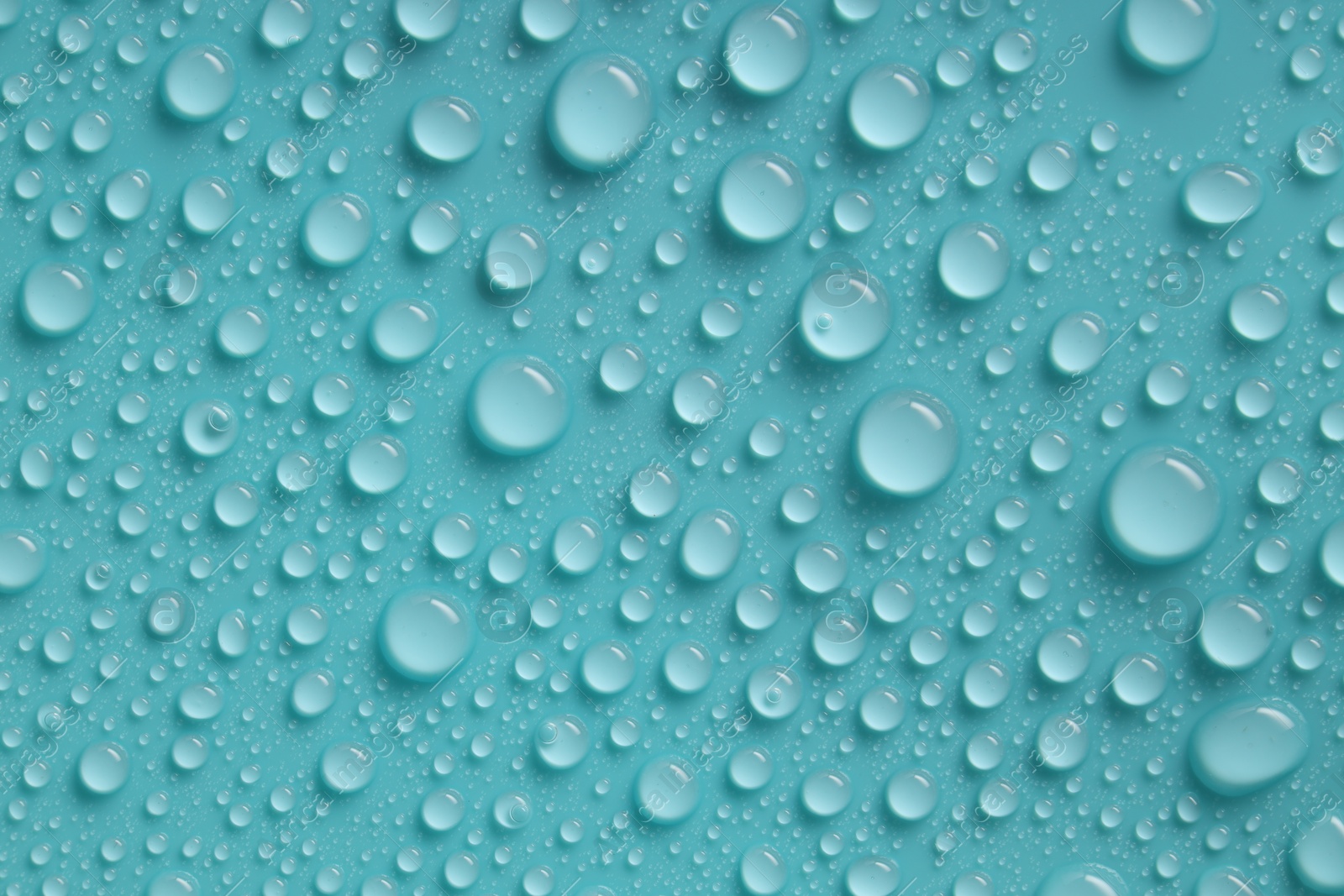 Photo of Water drops on turquoise background, above view