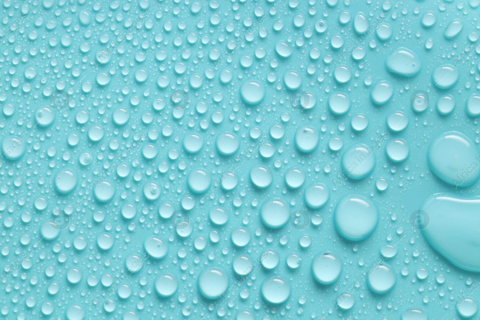 Photo of Water drops on turquoise background, above view