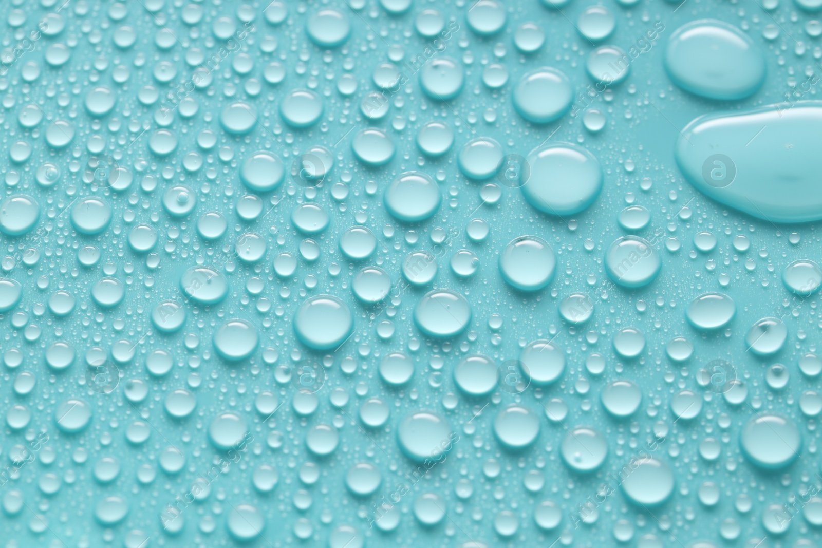 Photo of Water drops on turquoise background, above view