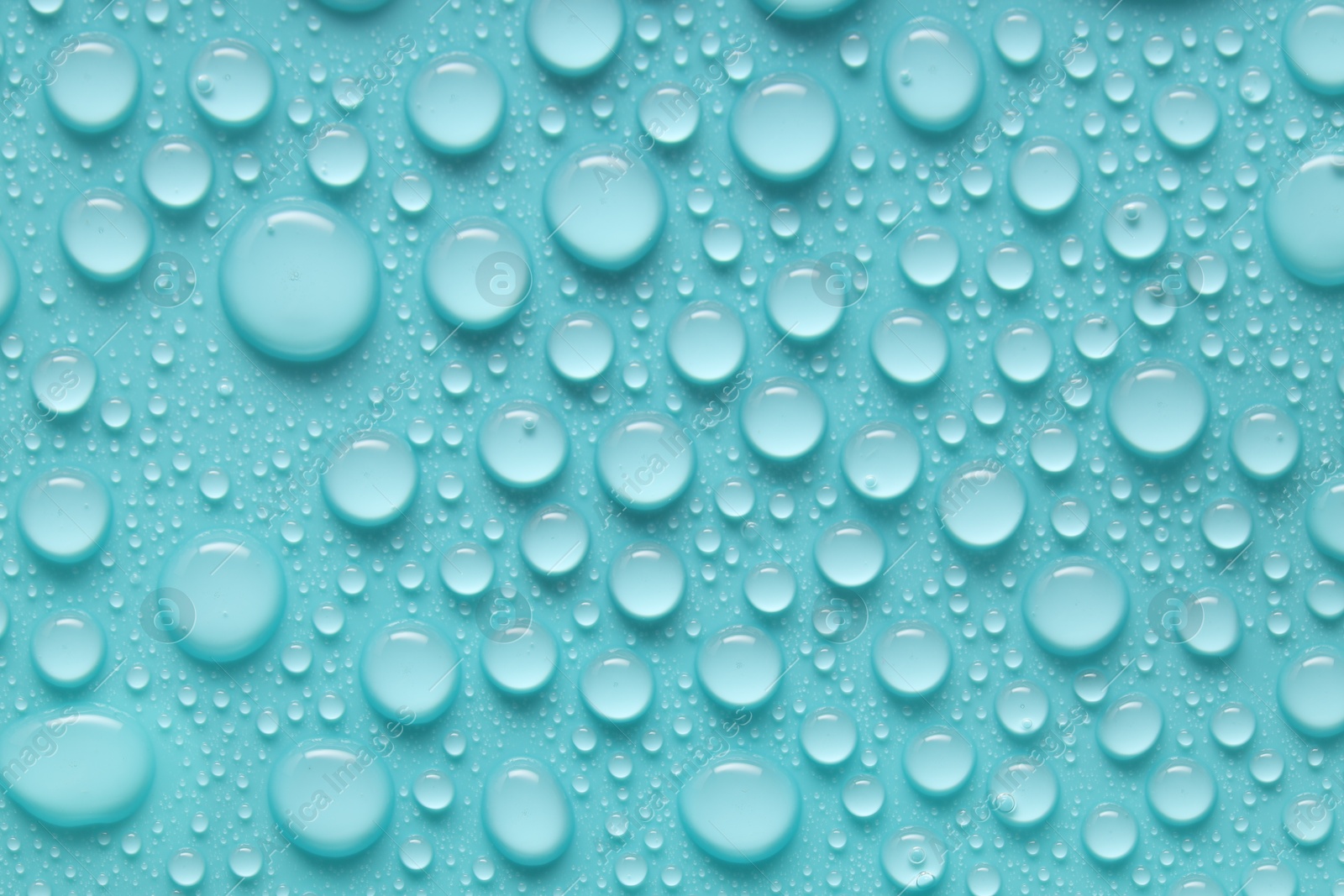 Photo of Water drops on turquoise background, above view