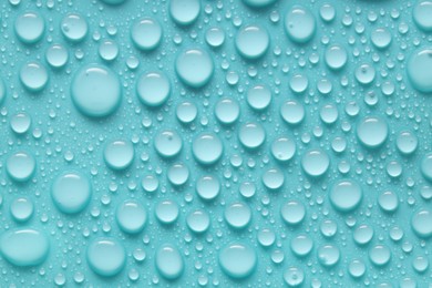 Photo of Water drops on turquoise background, above view