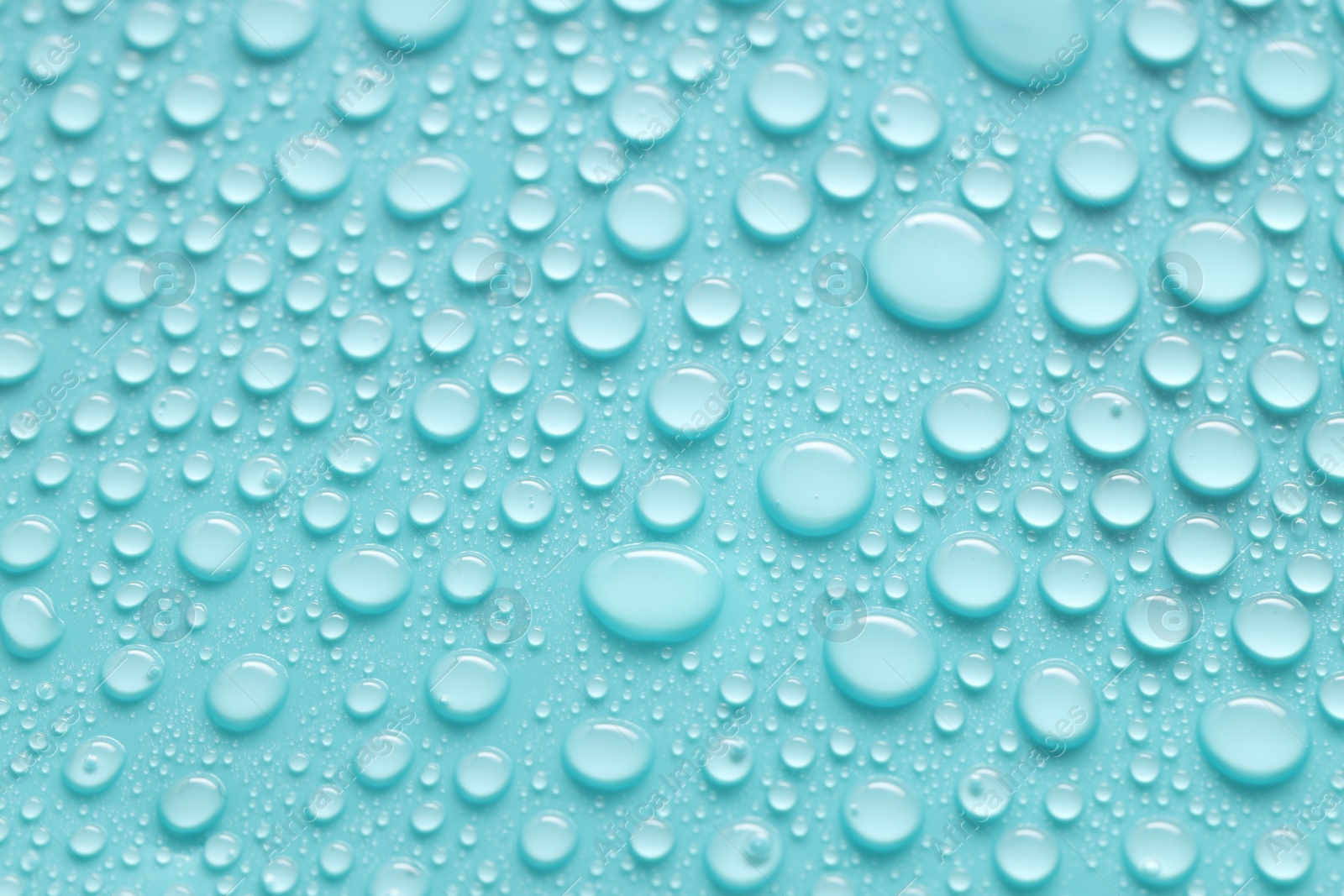 Photo of Water drops on turquoise background, above view