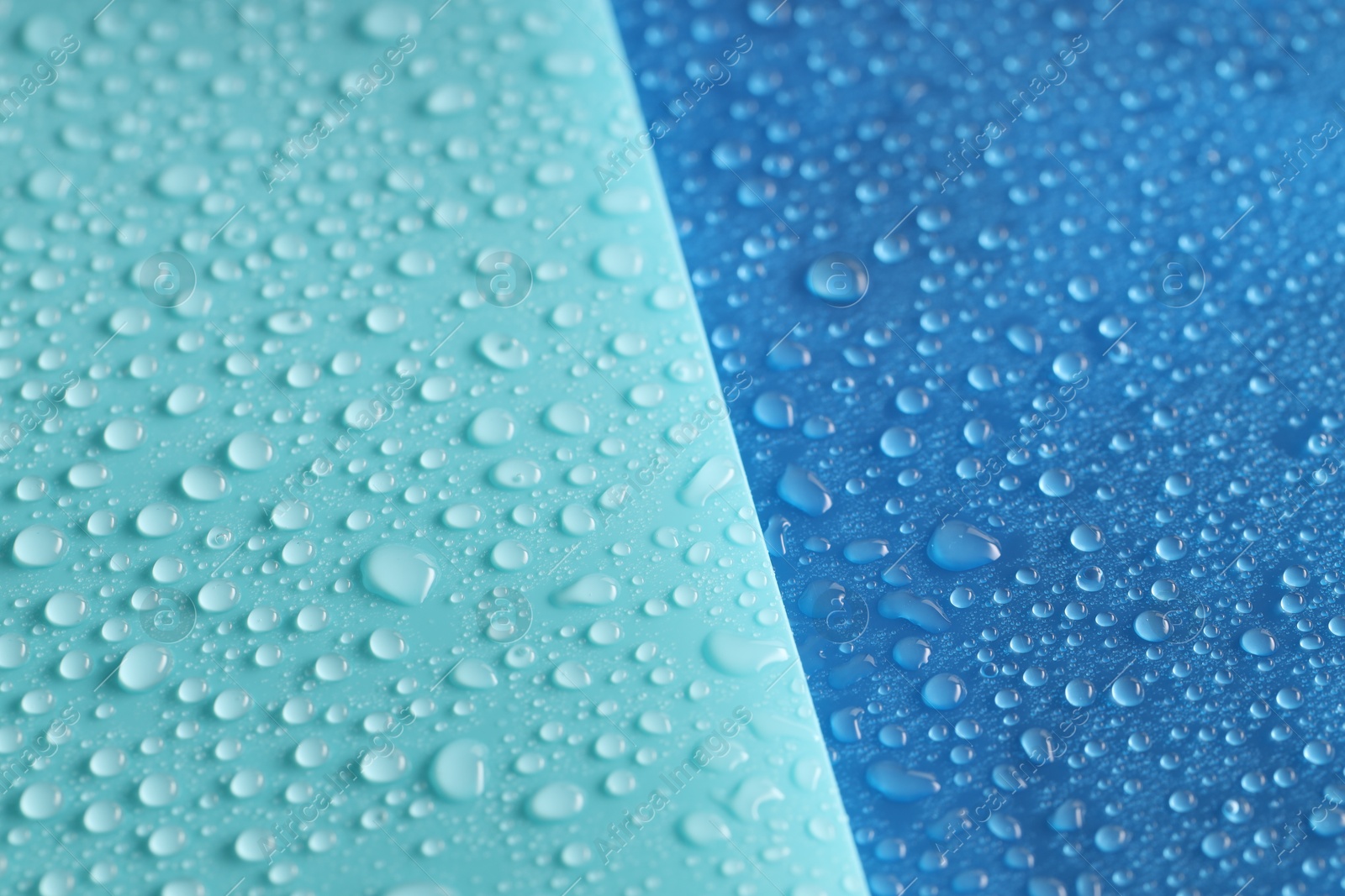 Photo of Water drops on color background, above view