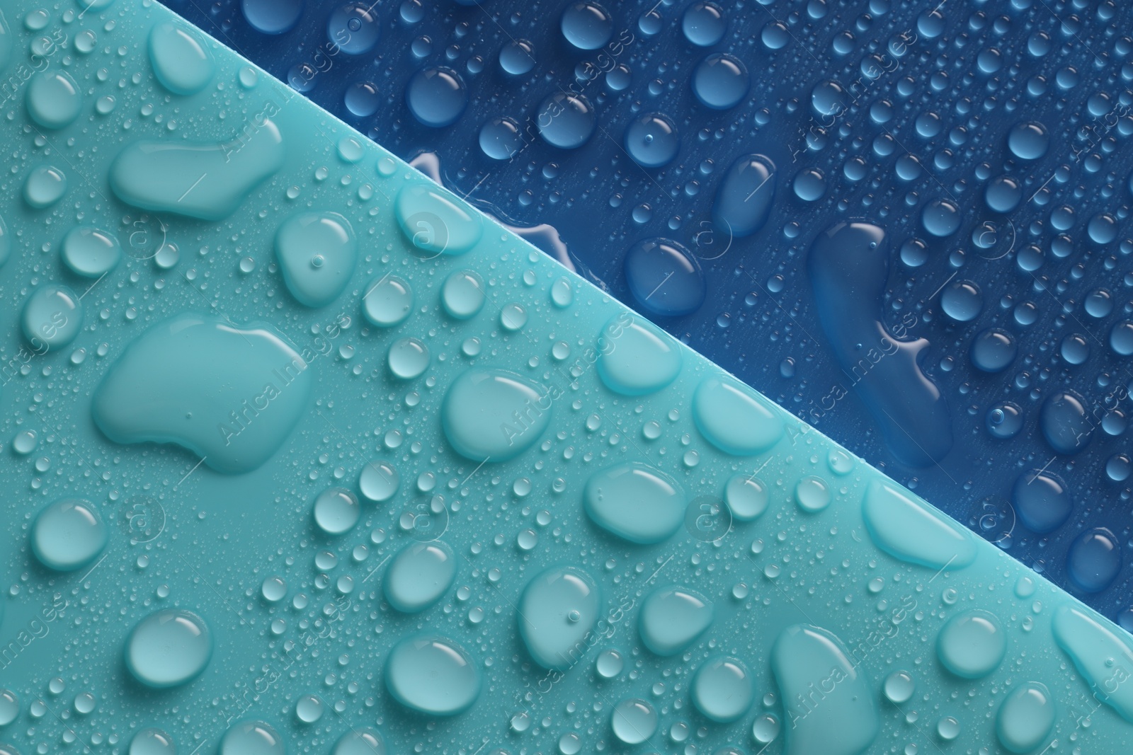 Photo of Water drops on color background, above view