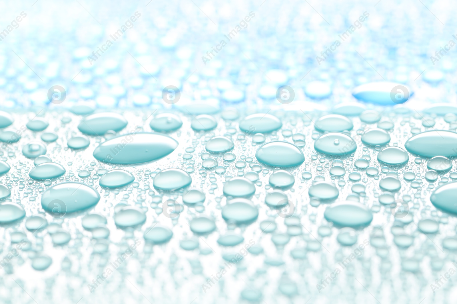 Photo of Water drops on turquoise background, above view