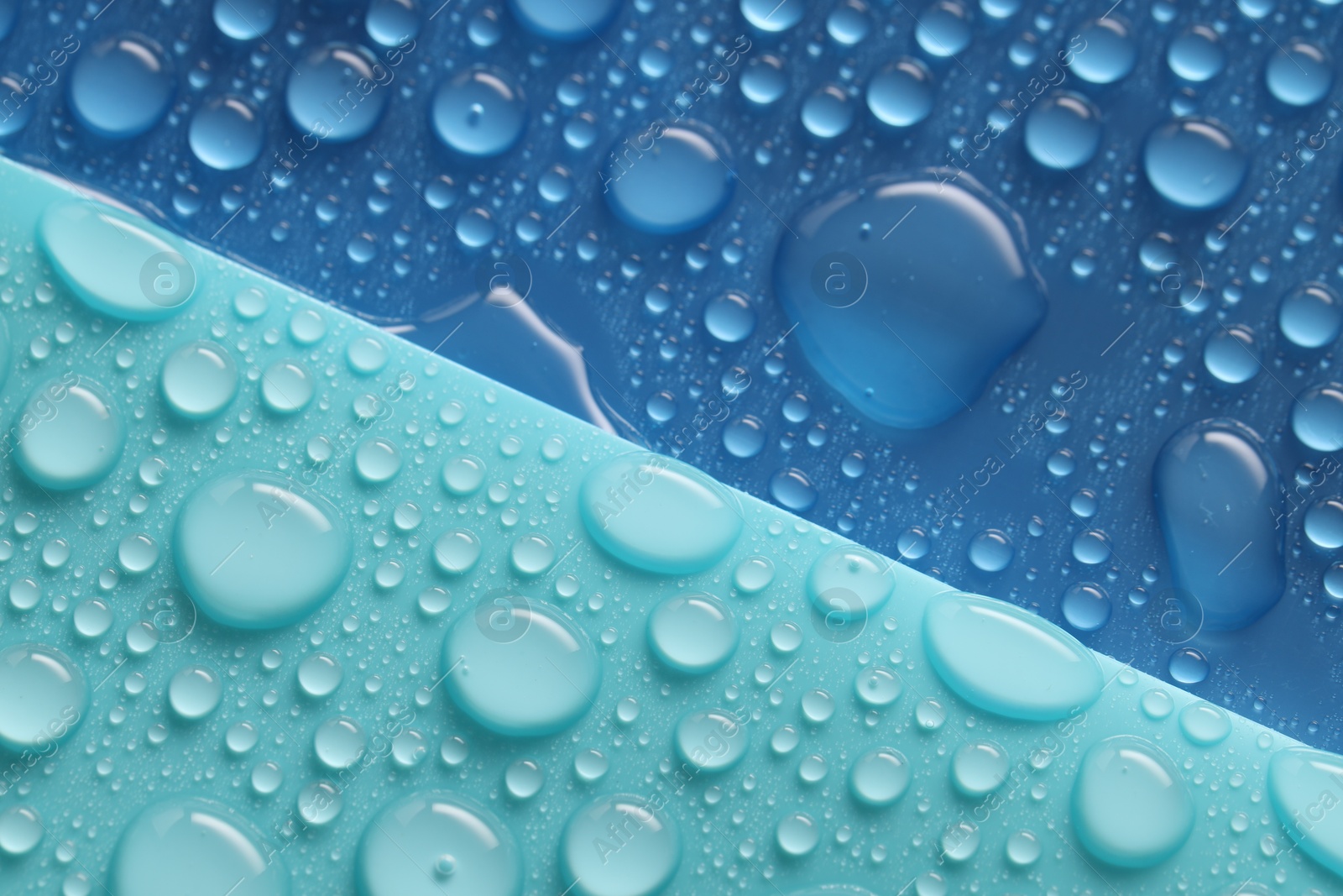 Photo of Water drops on color background, above view