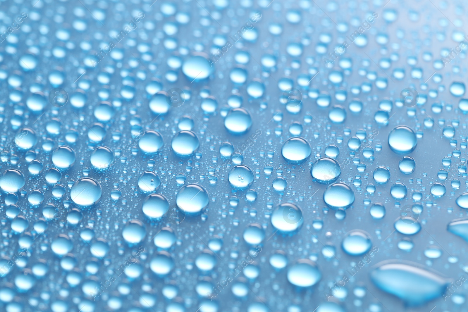 Photo of Water drops on light blue background, above view