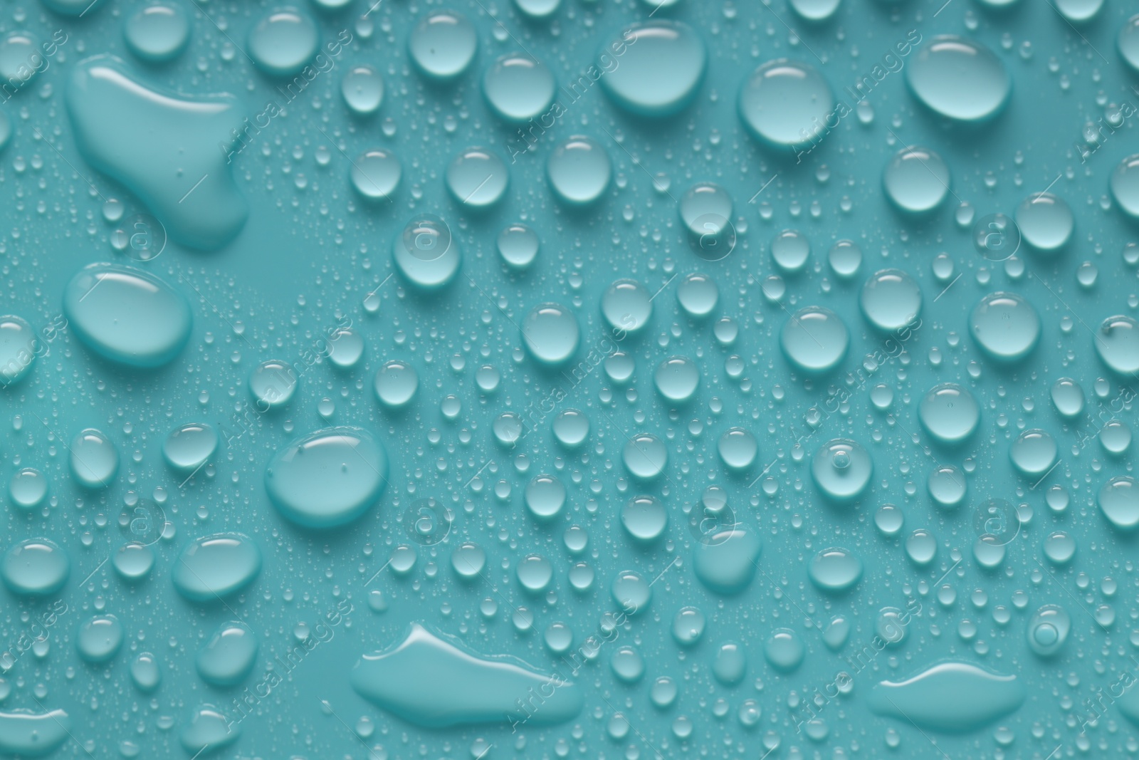 Photo of Water drops on turquoise background, above view