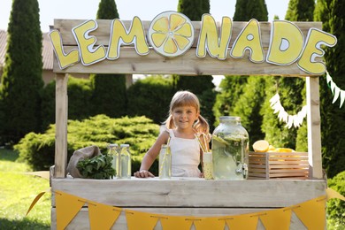 Cute little girl at lemonade stand in park