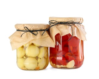 Photo of Different pickled products in jars isolated on white