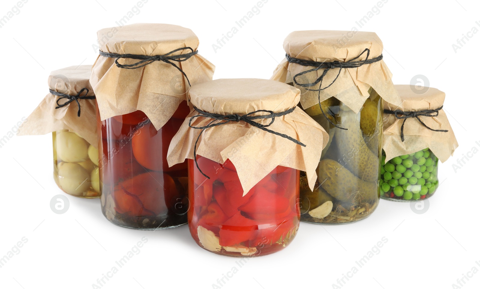 Photo of Different pickled products in jars isolated on white