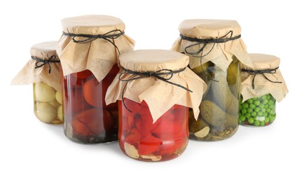 Photo of Different pickled products in jars isolated on white