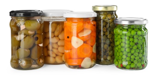 Photo of Different pickled products in jars isolated on white